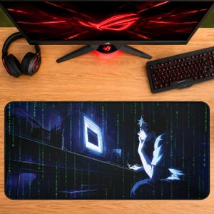 May include: A rectangular desk mat featuring a dark, digital-themed graphic of a person sitting at a computer terminal surrounded by vertical streams of green code. The mat has a black border and a smooth surface, positioned below a computer monitor.