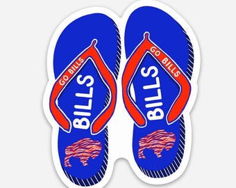 May include: Pair of blue flip-flops with red straps. The flip-flops have the word "BILLS" in white and the text "GO BILLS" in red. A red and brown buffalo logo is on the bottom of each flip-flop.