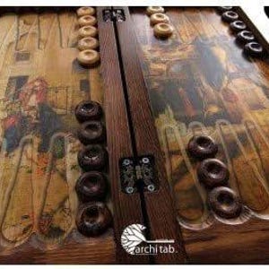 May include: A detailed view of a wooden backgammon board with dark brown and light tan checkers. The board features a vintage-style design with a central wooden divider and a decorative pattern on the playing surface. The game pieces are arranged for play.