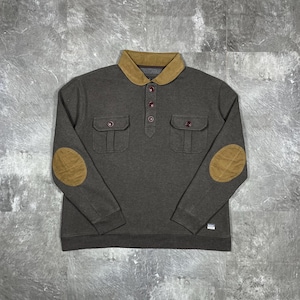 May include: A grey long-sleeved shirt with a brown collar and elbow patches. The shirt features two front pockets and three buttons. The elbow patches are oval.