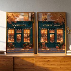 May include: Two framed vertical wall art prints depicting storefronts in autumn. The left print shows a teal bookshop with warm interior lighting and pumpkins outside. The right print shows a teal coffee shop with similar lighting and pumpkins.