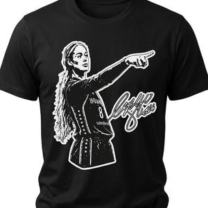 May include: A black short-sleeved t-shirt featuring a white graphic illustration of a basketball player with long hair pointing forward. The player wears a jersey with the number 8 and the text Indiana and Salesforce. A white signature is included.