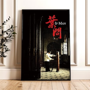 May include: A framed poster featuring the movie "Ip Man." The image shows a person in a white uniform practicing martial arts with a wooden dummy. The title is in red Chinese characters and English text.