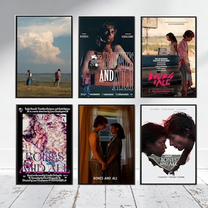 May include: A collection of six framed movie posters for Bones and All, featuring various scenes with two individuals, dramatic landscapes, and stylized text. The posters display cinematic imagery, including outdoor settings, interior shots, and artistic graphics.