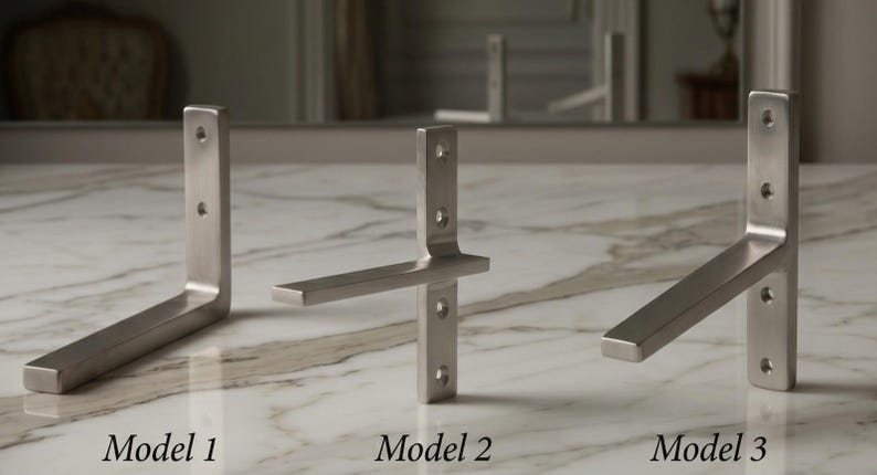 May include: Three brushed metal shelf brackets, each with a different design. Model 1 is an L-shape, Model 2 has a horizontal support, and Model 3 is angled. Each bracket has pre-drilled holes for mounting. The text "Model 1", "Model 2", and "Model 3" are below each bracket.