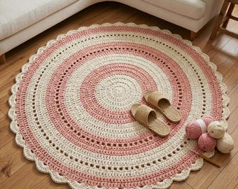 May include: A round, handmade crochet rug in shades of pink and cream, with a scalloped edge. The rug is on a hardwood floor, with a pair of woven sandals and several balls of yarn nearby. The rug's diameter is approximately 48 inches.