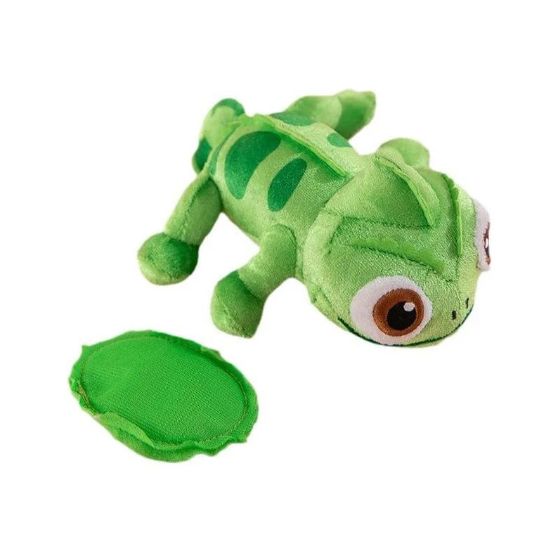 May include: A plush green chameleon toy with large brown and white eyes, and a separate green leaf-shaped piece. The chameleon has darker green spots and details. The toy is made of soft fabric.
