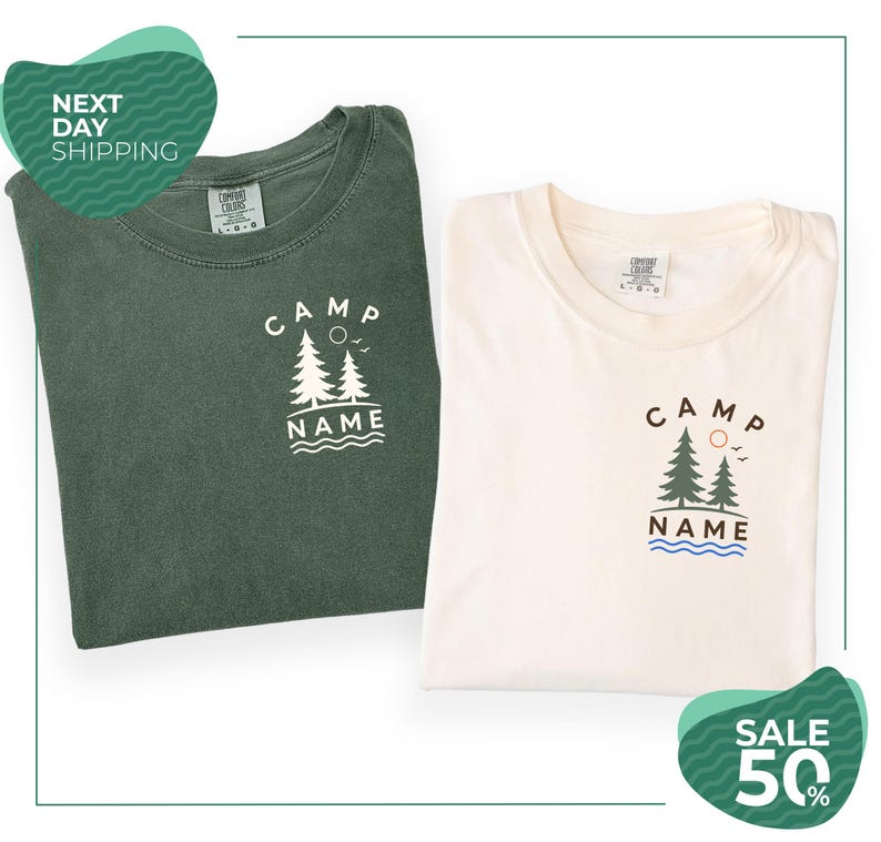 two t-shirts with the same design, one green and one white, both featuring the text "CAMP NAME" and a graphic of trees and waves. The t-shirts are folded and placed side by side, with a green and white background.