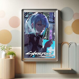 May include: Framed artwork featuring a stylized anime character with blue hair, set against a futuristic cityscape. The artwork has the text "Cyberpunk Edgerunners" in a stylized font, with a silver frame.