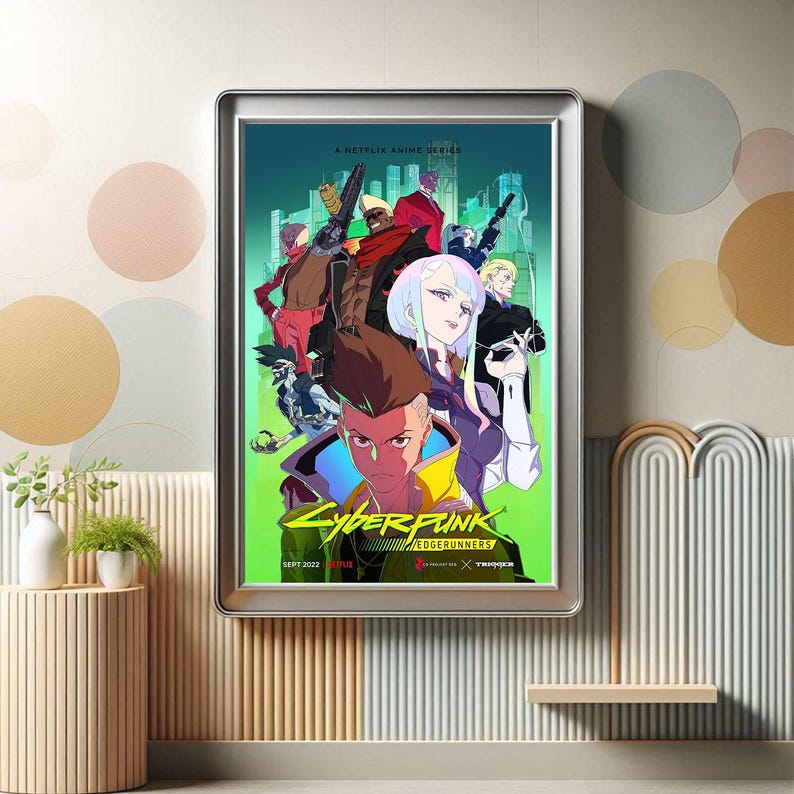 May include: A framed poster for the Netflix anime series "Cyberpunk: Edgerunners." The poster features a vibrant illustration of several characters in a futuristic cityscape. The poster has a silver frame and is displayed on a wall with decorative elements.