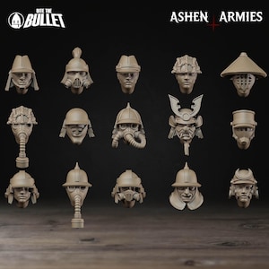 May include: A collection of beige-colored miniature head sculptures, each with unique helmet and mask designs. The heads are arranged in rows, showcasing various styles, including samurai, gas masks, and military helmets. The "Bite the Bullet" and "Ashen Armies" logos are visible.