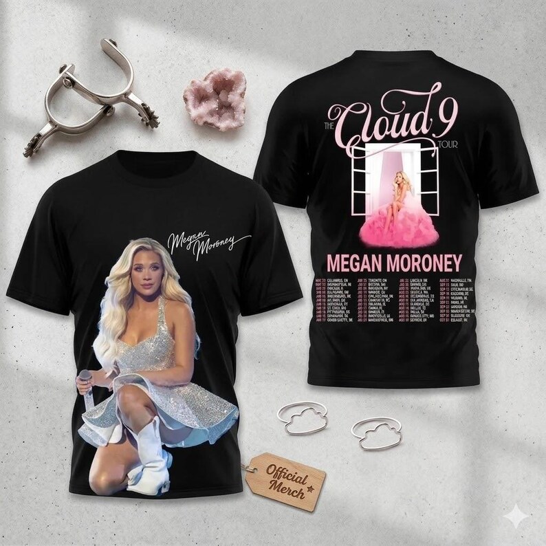 May include: Black t-shirts featuring singer Megan Moroney. One shirt displays a photo of Moroney in a silver dress, the other has "The Cloud 9 Tour" text and a tour date list. The shirts have the words "Megan Moroney" on them.