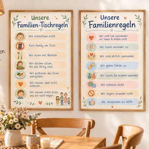 May include: Two rectangular wall posters in wooden frames featuring German text and colorful illustrations. The left poster is titled Unsere Familien-Tischregeln, and the right poster is titled Unsere Familienregeln, both listing various household rules.