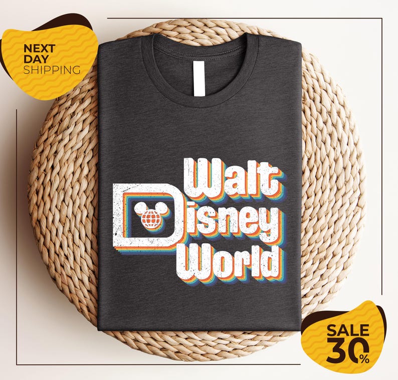 A black t-shirt with the text "Walt Disney World" printed on it, along with a Mickey Mouse logo. The t-shirt is displayed on a woven basket, and there are two yellow price tags in the image.