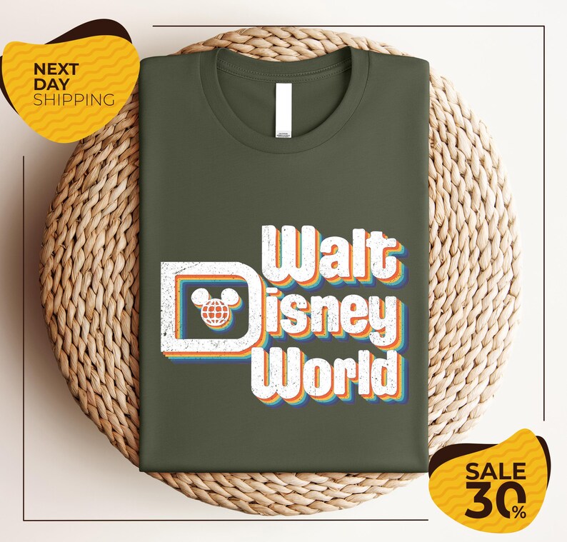 A green t-shirt with the text "Walt Disney World" printed on it, displayed on a woven basket.
