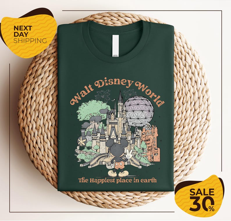 A green t-shirt with a graphic design of various Disney landmarks and the text "Walt Disney World" printed on it, placed on a woven basket.