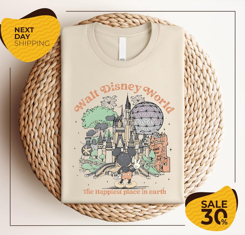 A t-shirt with a graphic design depicting various Disney landmarks and elements, including Mickey Mouse and the Eiffel Tower, along with the text "Walt Disney World" and "The Happiest place in earth". The t-shirt is displayed on a woven basket, and there are two yellow sale signs indicating a 30% discount.
