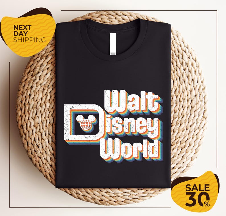 A black t-shirt with the text "Walt Disney World" printed on it, along with a Mickey Mouse logo. The t-shirt is displayed on a woven basket, and there are yellow price tags indicating a sale of 30% off.