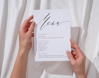 Pode incluir: Um cartão de menu retangular branco com texto preto apresentando a palavra Menu em uma fonte manuscrita no topo. O menu lista seções para Starter, Pasta Bar e Dessert com itens como garlic knots, ravioli e wedding cake em fonte serifada.