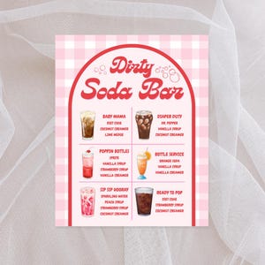 May include: A pink and white checkered sign with the words "Dirty Soda Bar" in red script. The sign lists six soda drink recipes, each with ingredients like coconut creamer, vanilla syrup, and strawberry syrup.