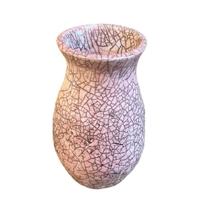 May include: A pink ceramic vase with a crackle glaze pattern. The vase has a rounded body and a flared rim. The crackle pattern is dark brown against the pink background. The vase is a decorative item.