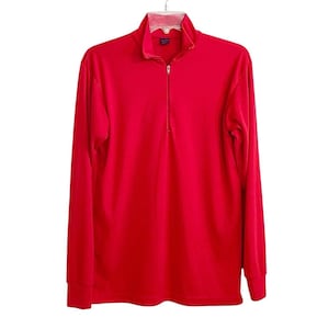 Op de afbeelding: Een felrood shirt met lange mouwen en een kwartritssluiting in het midden van de kraag. Het kledingstuk heeft een opstaande kraag, lange mouwen met geribbelde boorden en een gladde, effen gekleurde stoffen constructie.