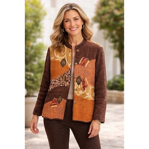 May include: A brown jacket with a round collar and long sleeves. The jacket features a patchwork design with shades of brown, orange, and tan. The design includes geometric shapes, animal print, and decorative embellishments. The jacket is buttoned up and worn by a person.