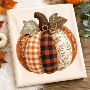 May include: A fabric pumpkin decoration featuring alternating panels of orange floral print, orange and white gingham, black and orange buffalo plaid, and a cream floral pattern. It has a brown ribbed stem, two green fabric leaves, and twine.