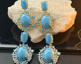 Pendientes colgantes ovalados azules con diamantes de imitación, joyería vintage llamativa en tono dorado.