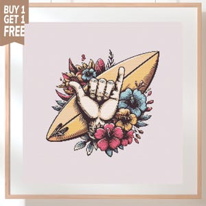 May include: A cross-stitch pattern featuring a tan surfboard positioned diagonally behind a hand making a shaka sign. The design is surrounded by colorful hibiscus flowers in shades of pink, blue, and yellow, all set against a light pink background.