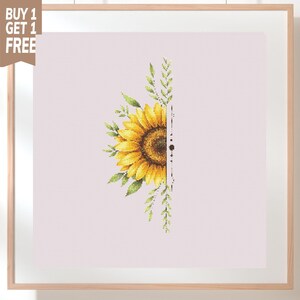 May include: A cross-stitch pattern featuring a half sunflower with yellow petals and a brown center, surrounded by green leaves and stems. The design is vertically bisected by a thin black line with a small dot, set against a light pink grid background.