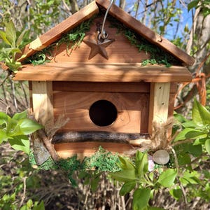 Rustic handcrafted cedar country birdhouse with rusty tin star and cleanout area