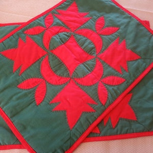 Set of two red and green applique fabric placemats