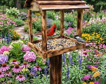May include: A wooden bird feeder with a scorched finish, featuring a roof and a central platform filled with mixed birdseed. A bright red cardinal and a small black-capped chickadee are perched on the feeder, eating the seeds.