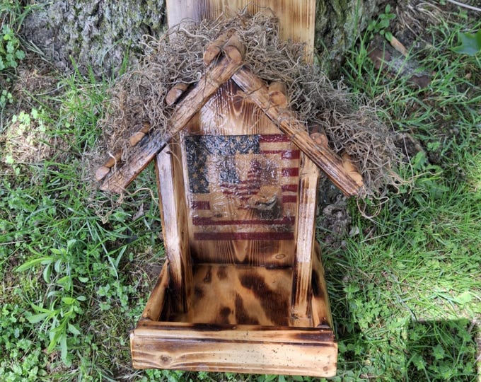 Handcrafted rustic open tree trunk feeder with crinkle flag panel on inside