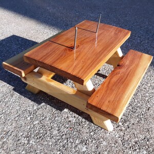 Spruce picnic table squirrel feeder ready for corn cobs