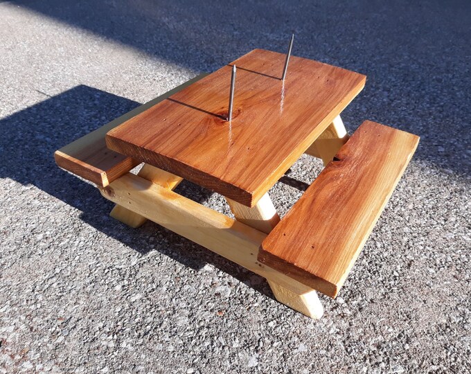 Spruce picnic table squirrel feeder ready for corn cobs