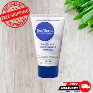 May include: A white tube of Dermend Mature Skin Solutions cream. The tube has a blue cap and a blue circle with the brand name. The text "fragile skin moisturizing formula" is displayed. The tube contains 127 g of cream.