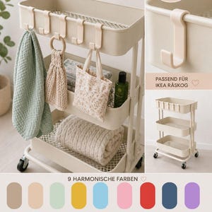 May include: A beige rolling utility cart with three shelves, holding towels, a tote bag, and other items. The image also shows a set of beige hooks designed for the cart, and a color palette of nine harmonious colors. Text on the image reads "RÅSKOG HAKEN".