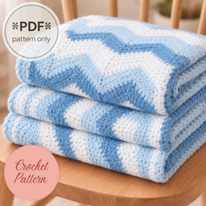 May include: A folded crochet blanket featuring a chevron pattern in alternating stripes of white and light blue. The image includes text that reads *PDF* pattern only and Crochet Pattern. The blanket is made of yarn with a visible textured stitch.
