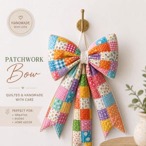 May include: A quilted patchwork bow featuring a vibrant array of colorful fabric squares in floral, gingham, and polka dot patterns. The bow is suspended from a gold-toned metal wall hook and includes long, pointed tails hanging downward.