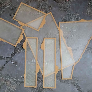 May include: A collection of six translucent, frosted acrylic panels with tan-colored frames. The set includes various geometric shapes, including rectangular and irregular polygonal pieces, arranged in a flat, overlapping composition.