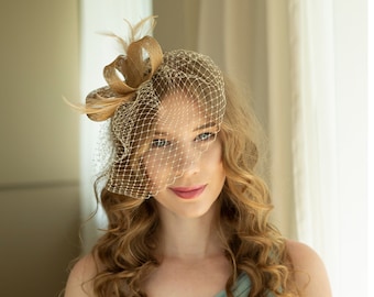 Gold fascinator with beige feathers and birdcage  veil, gold wedding guest fascinator, modern millinery headpiece