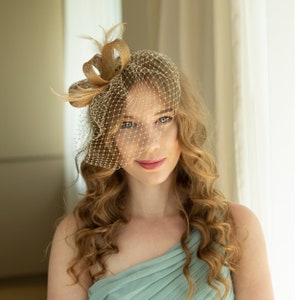 Gold fascinator with beige feathers and birdcage veil, gold wedding guest fascinator, modern millinery headpiece image 1