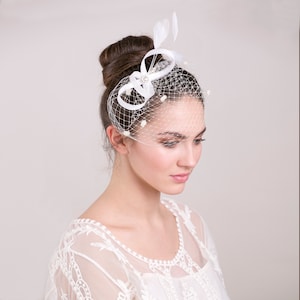 Bridal fascinator with dotted birdcage blusher, feather hairpiece for wedding, understated feather headpiece with short netting veil
