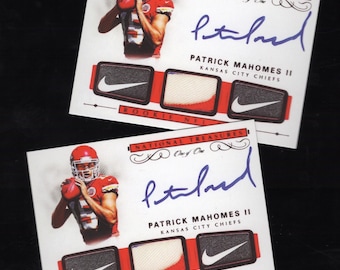 May include: Two National Treasures trading cards featuring Patrick Mahomes II of the Kansas City Chiefs. Each card displays a photo of the player, a blue ink autograph, and three embedded fabric swatches with two white Nike swoosh logos.