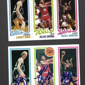 May include: A collection of vintage basketball trading cards featuring Larry Bird, Julius Erving, and Magic Johnson. Each card has a player image, team logo, and player name. The cards are in vibrant colors with a retro design.