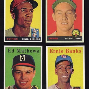 May include: Four vintage baseball cards featuring portraits of Frank Robinson, Al Kaline, Ed Mathews, and Ernie Banks. Each card displays the player's name, position, and team name, including the Cinn. Redlegs, Detroit Tigers, Milwaukee Braves, and Chicago Cubs.