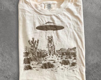 Retro Alien Raccoon Graphic Tee, UFO Desert Abduction Shirt, Y2K Sci Fi Western Style Top, Comfort Colors® Funny Animal Gift Tee