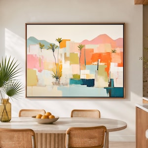 Peut inclure: Une œuvre d'art murale rectangulaire encadrée représentant un paysage abstrait avec des palmiers, des formes géométriques et des montagnes dans des tons orange, rose, jaune, bleu sarcelle et blanc, dans un cadre fin marron foncé.